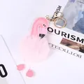 Close-up of pink flamingo pom-pom keychain with faux fur ball for bag decoration - Pink