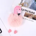 Detail shot of a pink plush flamingo keychain with heart-shaped feet. - Korean Pink