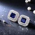 Close-up of elegant square blue zircon stud earrings featuring a sparkling diamond halo - Square Zirconia (Blue) / Blue
