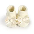 Detailed macro view of cream newborn baby girl socks with elegant lace and satin bow - 11cm / Off White