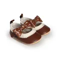 Detail view of brown baby princess shoes featuring a polka-dot bow and cream trim - Insole Length 11cm / Coffee
