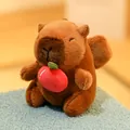 Adorable brown capybara plush toy holding a red apple on a soft fuzzy blue surface. - Angel Capybara Apple