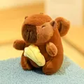 Cute brown capybara plush toy holding a yellow croissant accessory, soft and cuddly - Angel Capybara with Banana