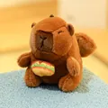Cute brown capybara plush toy with a colorful hamburger accessory on its belly - Angel Capybara Burger