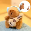 Cute brown capybara plush toy with blue earmuffs and functional pull-string guitar - Retractable Guitar Toy