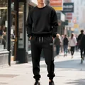 Full view of men's black heavy fleece sweatshirt and jogger set in street setting - S / Top And Bottom / Black