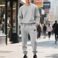 Lifestyle view of a men's grey heavy fleece crewneck sweatshirt and sweatpants set - S / Top And Bottom / Light Gray