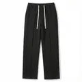 Detail shot of men's waffle knit casual pants showing elastic waist and texture. - S / Bottoms / Black