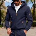 Detail shot of navy blue zip-up hoodie featuring orange zipper pulls and arm pockets - M / Tops / Navy Blue