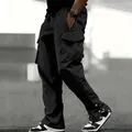 Men's loose black cargo pants with multiple pockets and snap buttons at the hem - S / Bottoms / Black