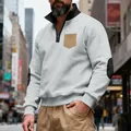 Detailed close-up of a men's grey heavy fleece quarter-zip sweatshirt with tan chest pocket - S / Tops / Light Gray