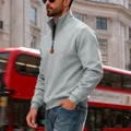Detail shot of a men's grey quarter-zip fleece sweatshirt worn in an urban street - S / Light Gray