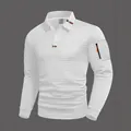 Dettaglio della polo bianca a maniche lunghe in maglia a nido d'ape con tasca zip - Taglia S / Top / Bianco