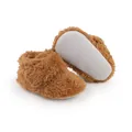 Close-up of brown fuzzy baby booties showing non-slip sole texture and plush fabric - 11cm / Coffee