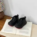 Toddler's black leather winter boots with warm plush lining displayed on a book - 16 / Black
