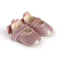 Close-up of pink glitter baby girl walking shoes with a bow detail on the back - 11cm / Pink