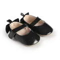 Detail view of black glitter baby Mary Jane shoes with bow decoration for infants. - 11cm / Black