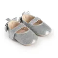 Close-up of silver glitter baby girl walker shoes with elegant bow detail decoration. - 11cm / Silver