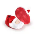 Detail view of red Santa Claus baby shoes with anti-slip dotted sole for winter. - Red