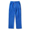 Detail view of blue plush men's sweatpants featuring drawstring and embroidered logo - S / Bottoms / Blue