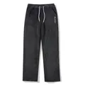 Detail of men's fuzzy black joggers with white drawstring and embroidery. - S / Bottoms / Black