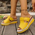 Close-up of yellow platform slide sandals with adjustable magic tape on wooden deck - Lemon Yellow