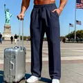 Men's loose straight-leg navy blue trousers shown in a travel lifestyle setting - S / Bottoms / Navy Blue