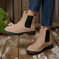 Side detail shot of women's khaki suede platform Chelsea boots featuring thick soles. - Khaki