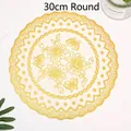 Detail view of 30cm round golden PVC bronzing placemat with floral butterfly pattern - Round Gold / 30cm Size