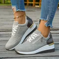 Detail shot of grey women's thick-soled casual sneakers with stylish gold heel accents - 37 / Gray