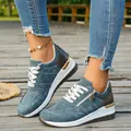 Detailed view of stylish blue-grey women's platform sneakers with gold accents and side zipper - Navy Blue
