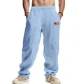 Detailed view of men's light blue linen wide-leg trousers with American flag patch. - S / Bottoms / Light Blue