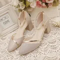 Macro view of champagne gold glitter pointed-toe sandals with ankle strap and block heel. - 34 / Ankle Strap Pointed Toe Style / Gold