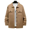 Detail view of a men's khaki heavy outdoor workwear jacket with buttoned flap pockets - Camel
