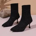 Close-up of black glittery knit sock boots with elegant stiletto heels and pointed toes - 36 / Black