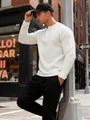 Outdoor lifestyle view of men's white waffle knit henley shirt in urban setting - White