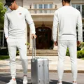 Men's white jacquard knit sweatshirt and pants tracksuit set shown in travel setting - S / Top And Bottom / White