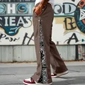 Detail shot of men's brown street style snap button trousers featuring paisley side panels - S / Bottoms / Brown