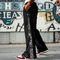 Detailed side view of black snap button pants with paisley pattern - S / Bottoms / Black