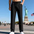Pantaloni casual neri da uomo, vestibilità dritta e ampia, mostrati in un ambiente aperto. - Taglia S / Pantaloni e gonne / Nero
