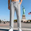 Pantaloni sportivi grigi larghi da uomo con coulisse elastica mostrati all'aperto - Grigio chiaro