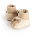 Close-up detail of beige baby sock shoes featuring a soft ribbed cuff and silk bow knot. - 11cm / Dark Khaki