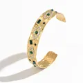 Detail of gold evil eye cuff bracelet with green gemstones and hammered texture - Green White Gem Hammered Style (S3218B)