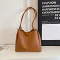 Minimalist brown faux leather tote bag featuring stylish knotted shoulder straps for women - Brown