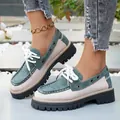 Detailed view of two-tone British style platform loafers with thick soles and white laces - 36 / Green