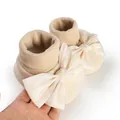 Detailed view of cream baby anti-slip floor socks featuring a large satin bowknot decoration - 11cm / Bowknot Style / Apricot
