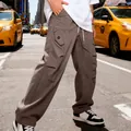 Primo piano dei pantaloni cargo pesanti da uomo a gamba larga in un contesto urbano - Taglia S / Pantaloni e gonne / Caffè