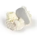 Detailed macro view of soft fuzzy baby winter booties with bow decoration and anti-slip sole. - 11cm / White