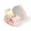 Detailed view of pink fuzzy winter baby booties with decorative bow and non-slip soles. - 11cm / Pink