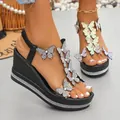 Elegant black wedge sandals with rhinestone butterfly details and sparkling platform sole. - 36 / Black